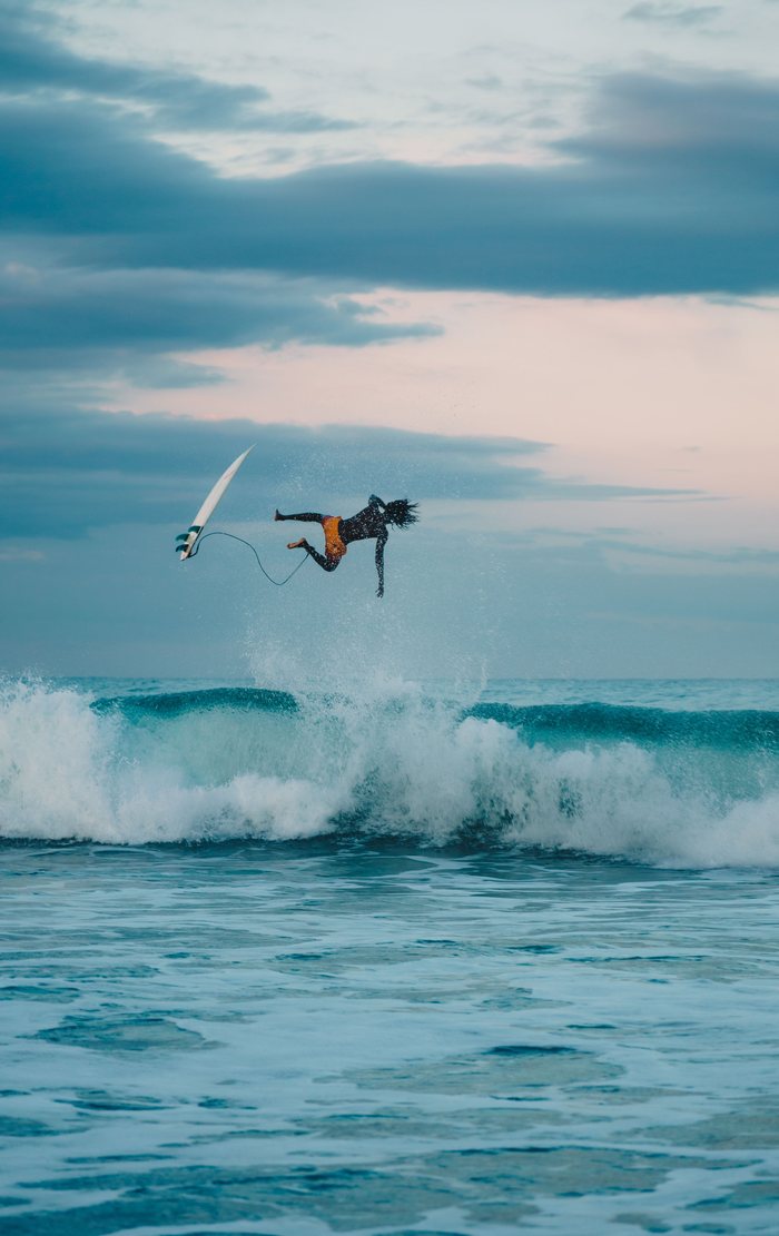 A surfer thrown clear of the board above a breaking wave at Arugam Bay