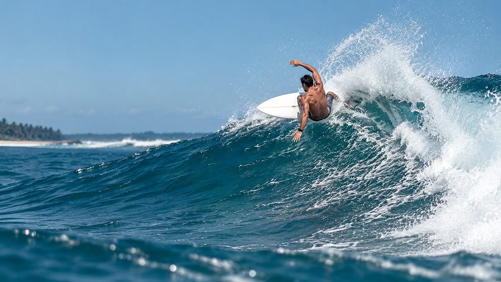 A surfer carving off the lip of a wave at Main Point, Arugam Bay, Sri Lanka