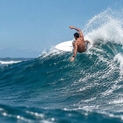 A surfer on the point break at Arugam Bay, Sri Lanka