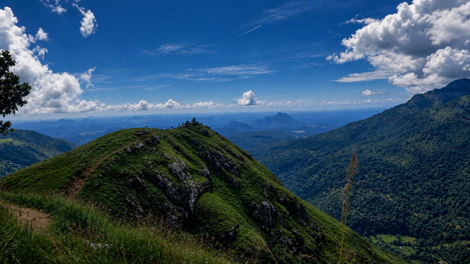 The green slopes of Little Adam’s Peak under blue sky