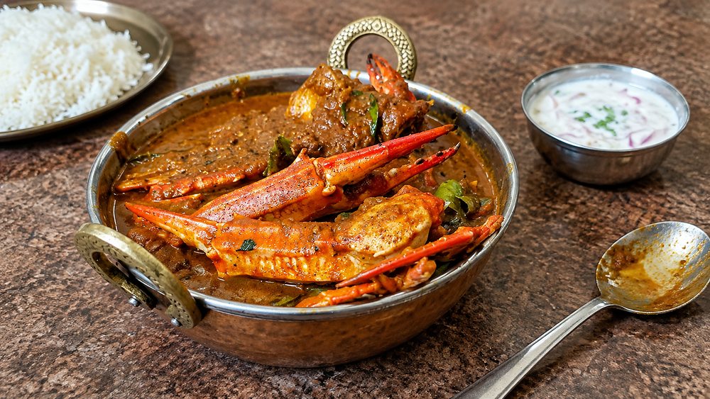 A Jaffna crab curry with claws in a dark roasted masala, served with rice, Sri Lanka