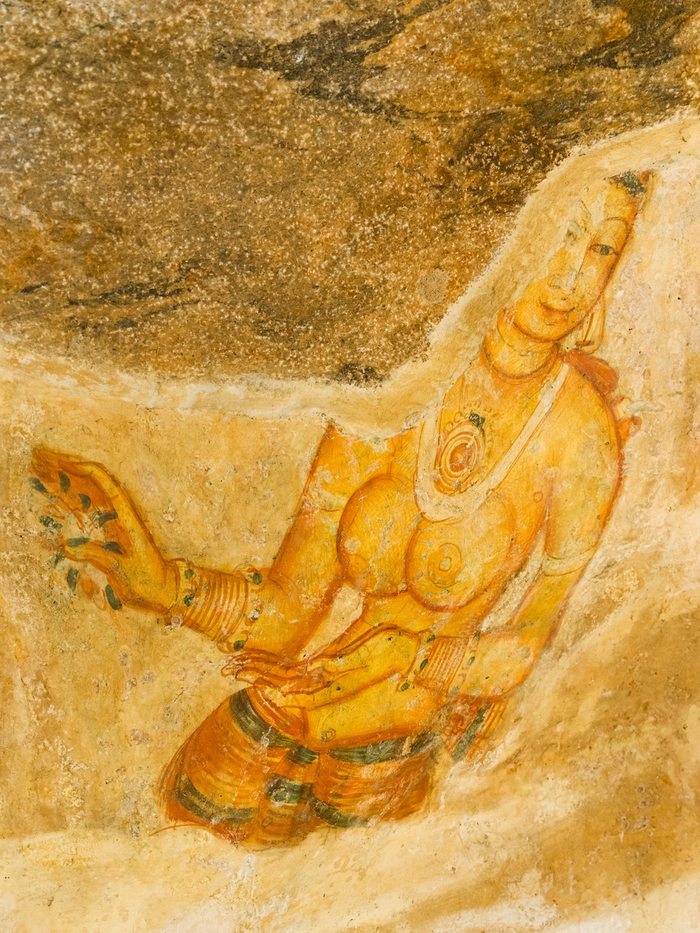 A fifth-century Sigiriya maiden painted in ochre on the rock face, Sri Lanka