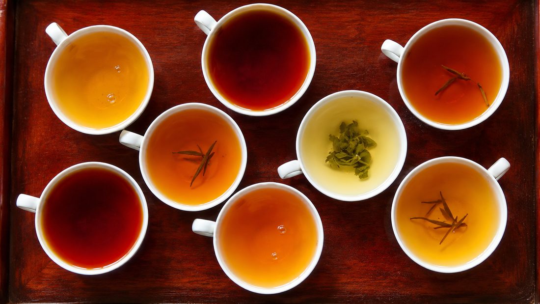 Seven cups of Ceylon tea at different strengths laid out for a tasting, Sri Lanka